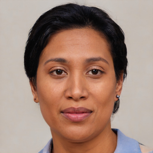 Joyful latino young-adult female with short  brown hair and brown eyes