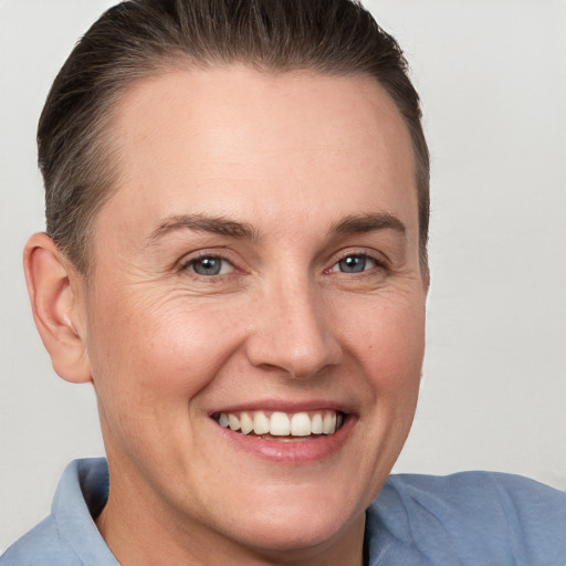 Joyful white adult female with short  brown hair and grey eyes