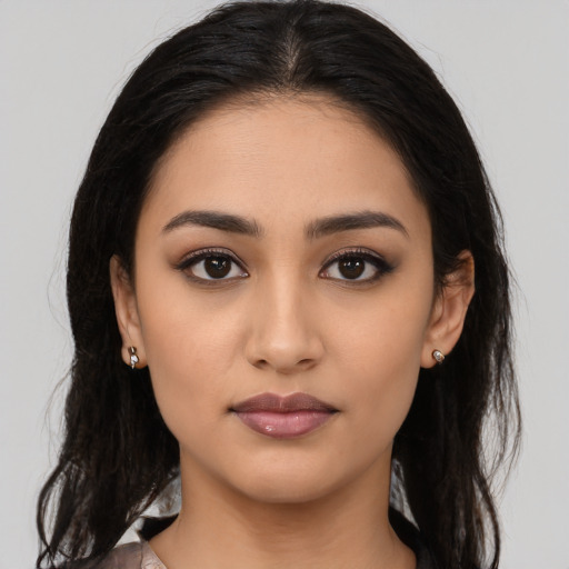 Neutral latino young-adult female with long  brown hair and brown eyes