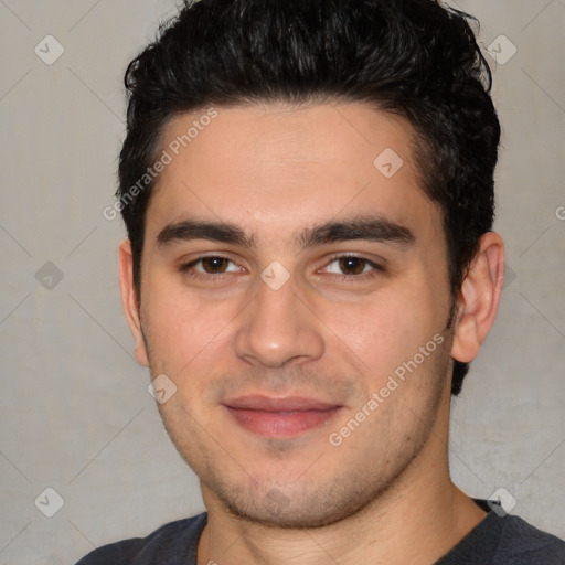 Joyful white young-adult male with short  black hair and brown eyes