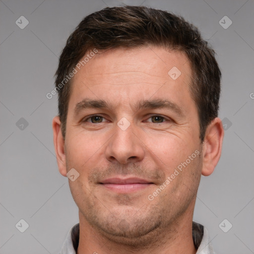 Joyful white adult male with short  brown hair and brown eyes