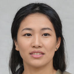 Joyful asian young-adult female with medium  black hair and brown eyes