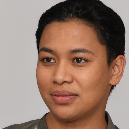Joyful latino young-adult female with short  black hair and brown eyes