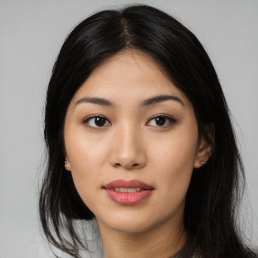 Joyful asian young-adult female with long  black hair and brown eyes