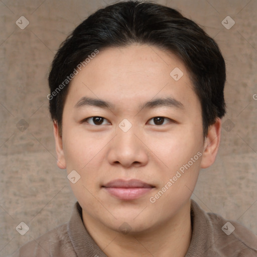 Joyful asian young-adult male with short  brown hair and brown eyes