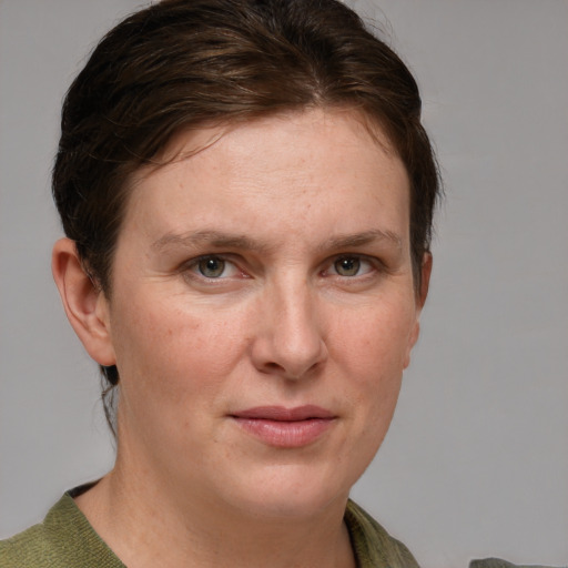 Joyful white adult female with medium  brown hair and grey eyes