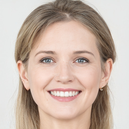 Joyful white young-adult female with long  brown hair and grey eyes