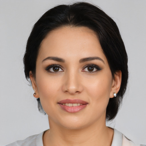 Joyful latino young-adult female with medium  black hair and brown eyes