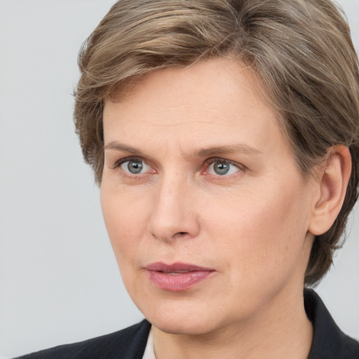 Joyful white adult female with medium  brown hair and grey eyes