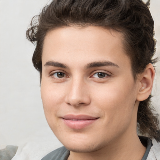 Joyful white young-adult male with medium  brown hair and brown eyes