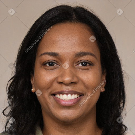 Joyful black young-adult female with long  black hair and brown eyes