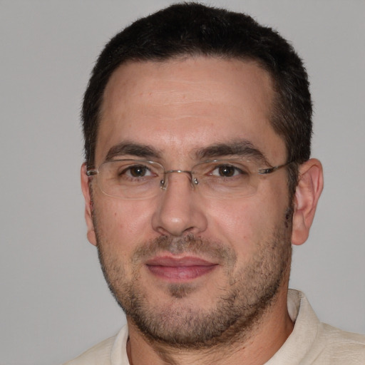 Joyful white adult male with short  black hair and brown eyes