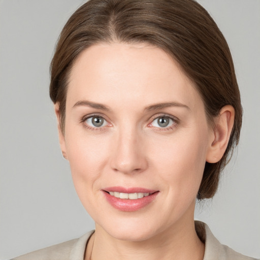 Joyful white young-adult female with medium  brown hair and grey eyes