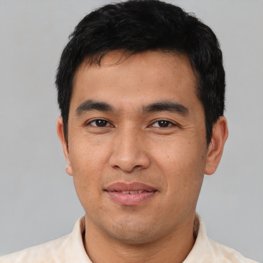 Joyful white young-adult male with short  black hair and brown eyes