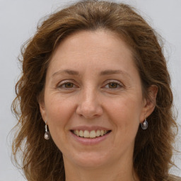 Joyful white adult female with long  brown hair and grey eyes