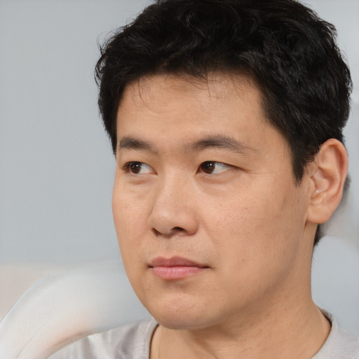 Neutral asian young-adult male with short  black hair and brown eyes
