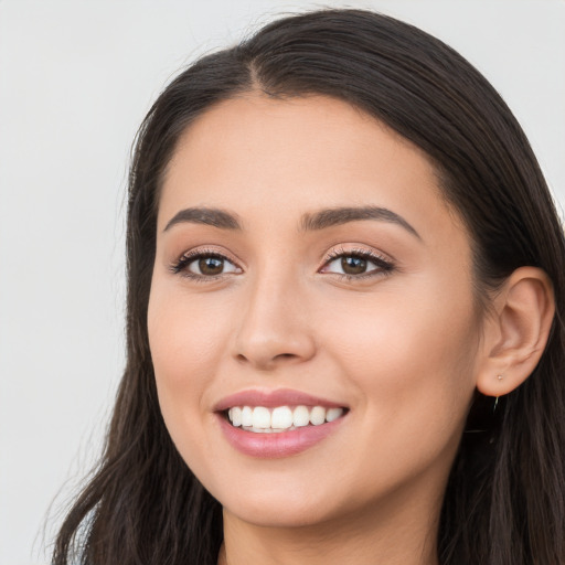 Joyful white young-adult female with long  black hair and brown eyes