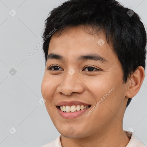 Joyful asian young-adult male with short  black hair and brown eyes