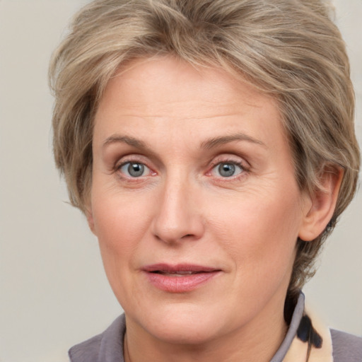 Joyful white adult female with medium  brown hair and grey eyes