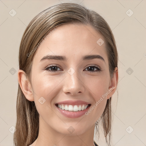 Joyful white young-adult female with long  brown hair and brown eyes