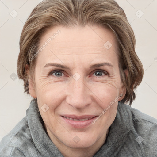 Joyful white adult female with medium  brown hair and grey eyes