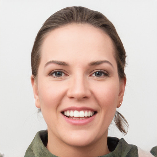 Joyful white young-adult female with medium  brown hair and grey eyes