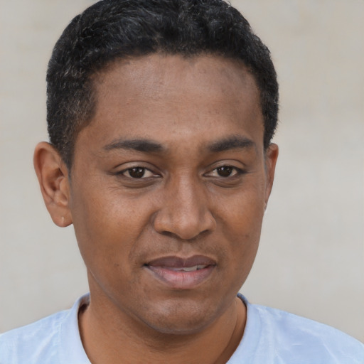 Joyful latino young-adult male with short  brown hair and brown eyes