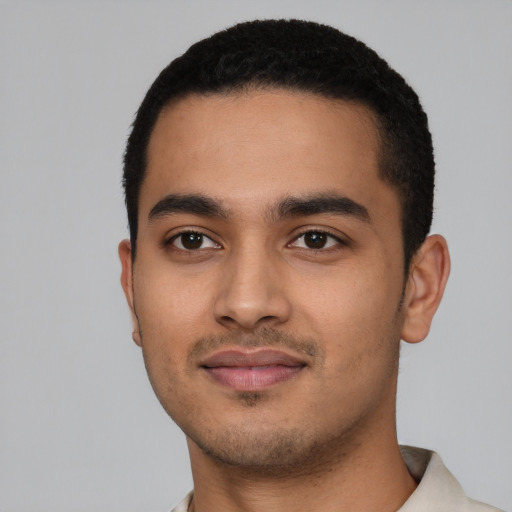 Joyful latino young-adult male with short  black hair and brown eyes