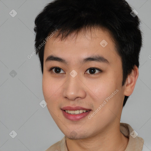 Joyful asian young-adult male with short  brown hair and brown eyes