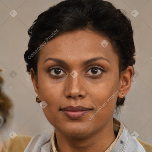 Joyful black young-adult female with short  brown hair and brown eyes