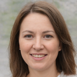 Joyful white adult female with medium  brown hair and brown eyes