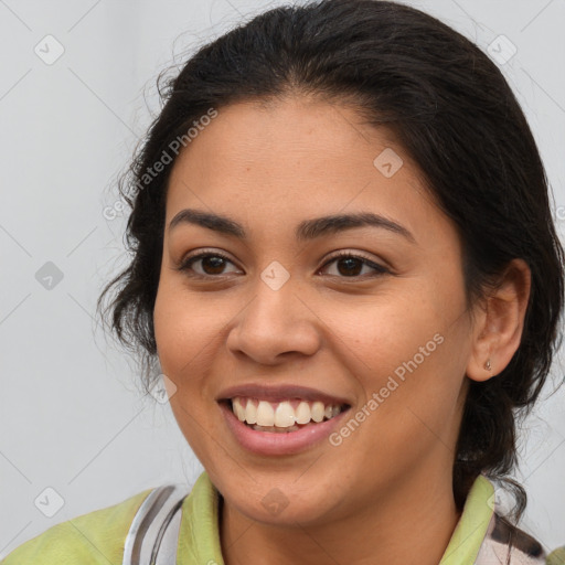 Joyful latino young-adult female with medium  brown hair and brown eyes