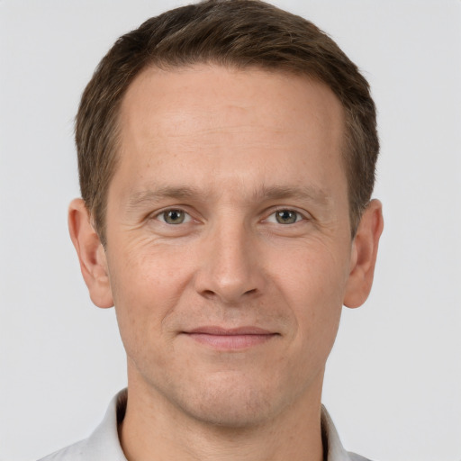 Joyful white adult male with short  brown hair and grey eyes