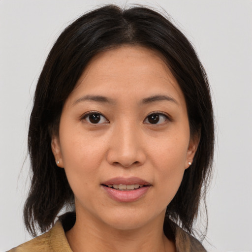 Joyful asian young-adult female with medium  brown hair and brown eyes