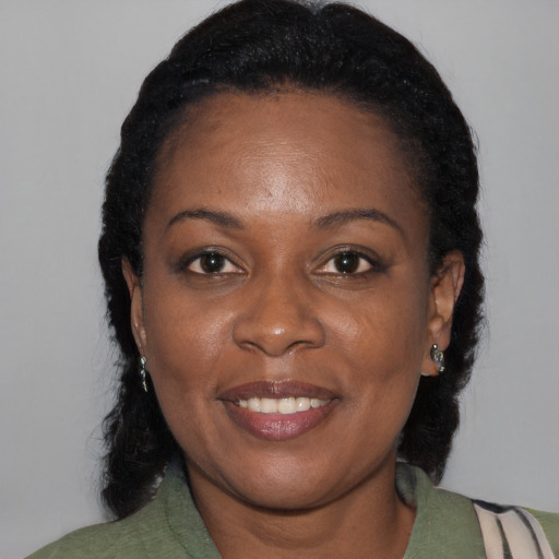 Joyful black young-adult female with medium  black hair and brown eyes