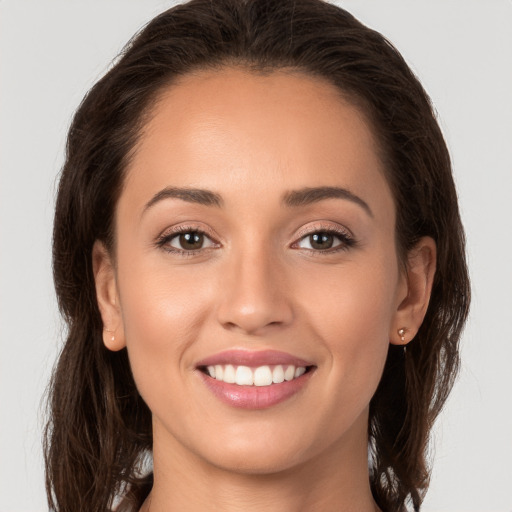 Joyful white young-adult female with long  brown hair and brown eyes