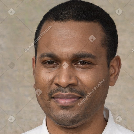 Joyful latino adult male with short  black hair and brown eyes