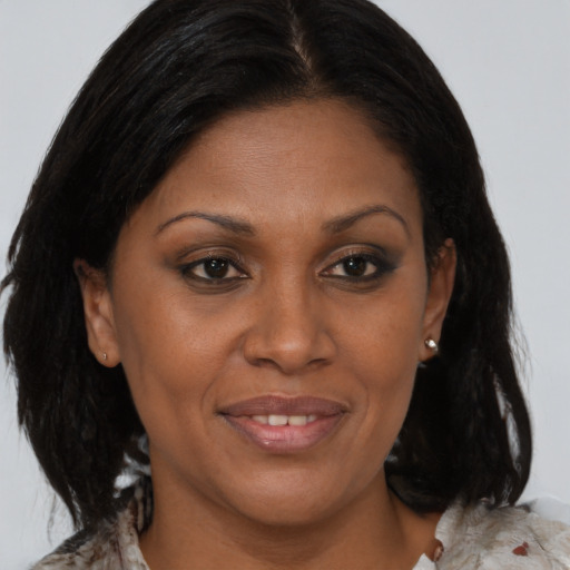 Joyful black adult female with medium  brown hair and brown eyes