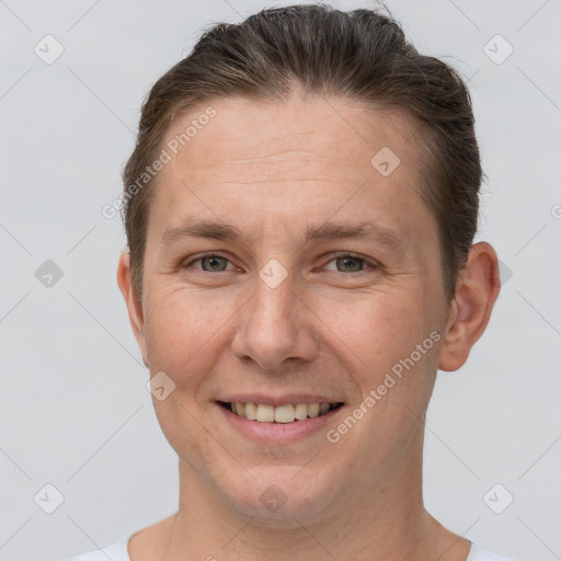 Joyful white adult female with short  brown hair and grey eyes