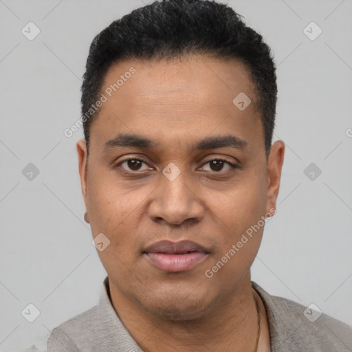 Joyful black young-adult male with short  black hair and brown eyes