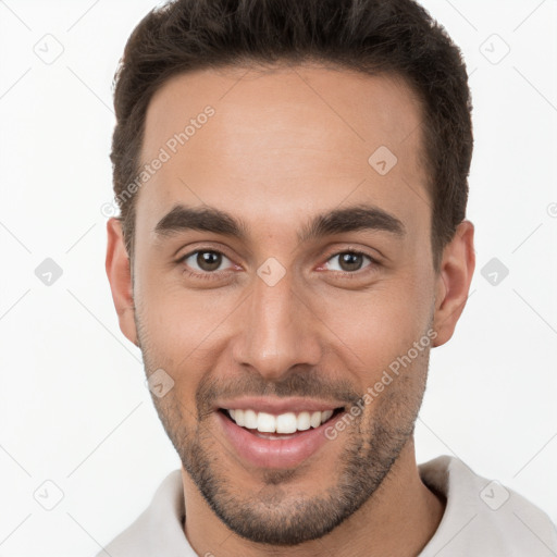 Joyful white young-adult male with short  brown hair and brown eyes