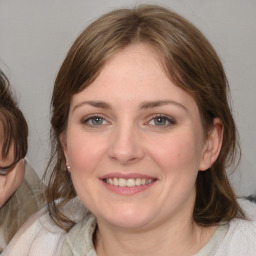 Joyful white young-adult female with medium  brown hair and blue eyes