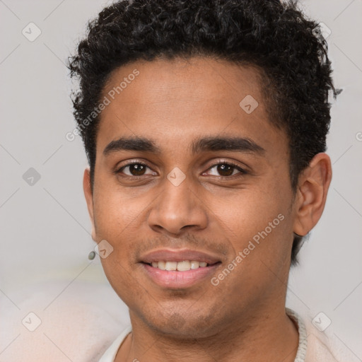 Joyful black young-adult male with short  brown hair and brown eyes