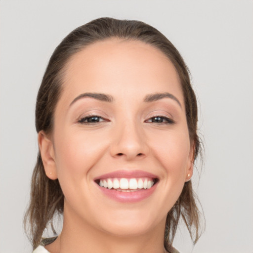 Joyful white young-adult female with medium  brown hair and brown eyes