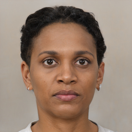 Joyful black young-adult female with short  brown hair and brown eyes