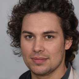 Joyful white young-adult male with medium  brown hair and brown eyes