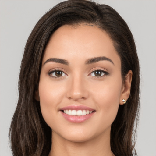 Joyful white young-adult female with long  brown hair and brown eyes