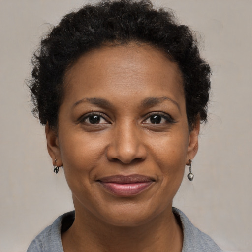 Joyful black adult female with short  brown hair and brown eyes