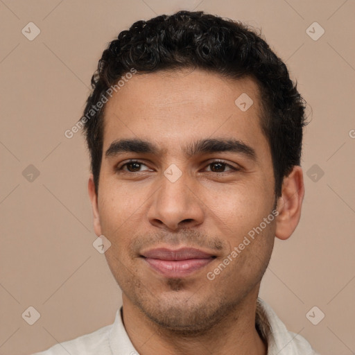 Joyful white young-adult male with short  black hair and brown eyes