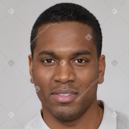 Joyful black young-adult male with short  black hair and brown eyes